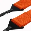 Close-up of two orange straps with black metal attachments. Náhled obrázku produktu