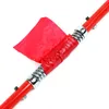 A close-up shot of a red tow bar with silver springs and a red flag attached. Podgląd zdjęcia produktu