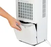 A hand is shown pulling out the water collection tank from a white dehumidifier. Produktbild-Vorschau