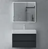 A modern bathroom vanity with a mirror cabinet and faucet against a concrete wall. Produktbild-Vorschau