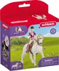 A toy horse and rider set in its packaging, set against a grassy field background. Náhľad obrázku produktu