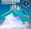A teal and gray handheld vacuum cleaner with UV-C light emitting from its head, shown cleaning a surface. Produktbild-Vorschau