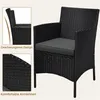 A black rattan chair with a gray cushion, shown with close-up details of its design and armrests. Produktbild-Vorschau
