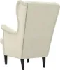 The back view of a cream-colored velvet wingback chair with dark legs, isolated on a white background. Náhľad obrázku produktu