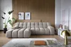 A modern living room with a sectional sofa, plants, and artwork. Voir les images du produit