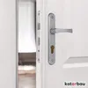 A close-up view of a silver door handle and lock mechanism on a white door. Produktbild-Vorschau