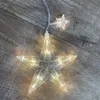 A string of star-shaped LED lights on a wooden surface. Produktbild-Vorschau