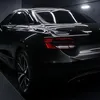 A black car is shown from the rear in a studio setting. Náhled obrázku produktu