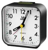 A close-up studio shot of a black analog alarm clock. Produktbild-Vorschau