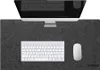 A desk setup with a computer monitor, keyboard, and mouse on a gray desk mat. Produktbild-Vorschau