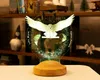 A Harry Potter-themed night light featuring Hedwig the owl is displayed on a table in front of a bookshelf. Produktbild-Vorschau
