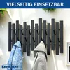 A black metal wall coat rack with multiple hooks, holding two jackets. Produktbild-Vorschau