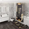 A modern bathroom with a toilet, sink, bathtub, and shower curtain. Produktbild-Vorschau