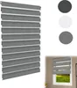 A product shot of a grey zebra blind with samples of different colors shown. Voir les images du produit