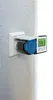 A device is mounted on a textured wall, showing a digital display. Anteprima dell’immagine prodotto