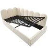 A beige upholstered bed frame with a metal slatted base, shown from a diagonal angle. Voir les images du produit