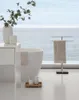 A modern bathroom scene with a bathtub, sink, and towel rack overlooking the ocean. Produktbild-Vorschau