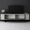 A modern TV stand with a TV on it in a room with dark gray walls and light gray floor. Produktbild-Vorschau