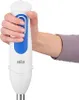 A hand holding a white and blue Braun immersion blender. Produktbild-Vorschau