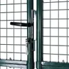 Close-up of a green metal gate lock mechanism with keys. Anteprima dell’immagine prodotto
