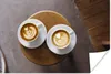 MuchoWow® Poster Zwei Tassen Kaffee mit Latte Art werden Produktbild-Vorschau 1