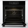 An open oven with racks and baking trays inside, set against a white kitchen background. Voir les images du produit