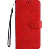 A red flip case for a Samsung Galaxy A14 with a sunflower embossed pattern and a wrist strap. Produktbild-Vorschau