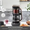 A tea maker is shown on a countertop with cups and some pastries. Produktbild-Vorschau