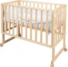 A wooden crib with bedding on a white background. Produktbild-Vorschau