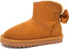 A single brown winter boot with a white fluffy lining and a brown bow on the back, shown against a white background. Produktbild-Vorschau