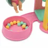 A close-up shot of a toy playset, featuring a ball pit filled with colorful balls and a baby doll. Podgląd zdjęcia produktu