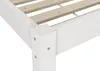 Close-up of the corner of a white wooden bed frame with wooden slats. Produktbild-Vorschau