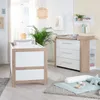 A nursery room with a crib and a changing table. Anteprima dell’immagine prodotto