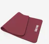 A dark red yoga mat is shown on a white background. Náhľad obrázku produktu