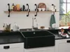 A modern kitchen sink area with a black sink and a silver faucet. Produktbild-Vorschau