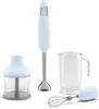 A light blue Smeg hand blender set is displayed against a white background. The set includes the hand blender, a chopper attachment, a beaker, and a whisk attachment. Produktbild-Vorschau
