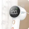 Close-up of a white electric lint remover with a digital display showing 100% charge. Náhled obrázku produktu