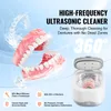 A high-frequency ultrasonic cleaner for dentures, showing the dentures being cleaned and highlighting features. Produktbild-Vorschau