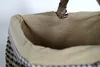 A close-up view of the inside of a woven basket with a fabric lining. Produktbild-Vorschau