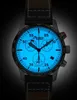A close-up shot of a luminous watch face with a dark background. Náhled obrázku produktu