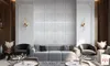 A modern living room with a large sofa, armchairs, and decorative wall panels. Produktbild-Vorschau