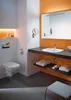 A modern bathroom with a wall-mounted toilet and a sink vanity. Produktbild-Vorschau