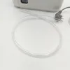 A close-up view of a clear plastic tube and a power cord connected to a device. Voir les images du produit