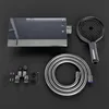 A set of bathroom fixtures including a showerhead, hose, and control unit, laid out on a dark surface. Produktbild-Vorschau