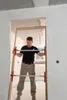 A man is installing a door frame in a room under construction. Anteprima dell’immagine prodotto