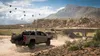 A desert landscape with vehicles and hot air balloons. Produktbild-Vorschau