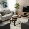 A living room scene with a couch, coffee tables, and a TV. Voir les images du produit