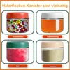 Four glass jars with lids, each containing a different food item, are displayed in a grid layout. Labels are present below each jar. Produktbild-Vorschau