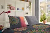 A bedroom scene with bedding and decorative items on a shelf. Produktbild-Vorschau