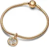 A gold Pandora bracelet with a circular charm featuring a constellation design and small clear stones. Podgląd zdjęcia produktu